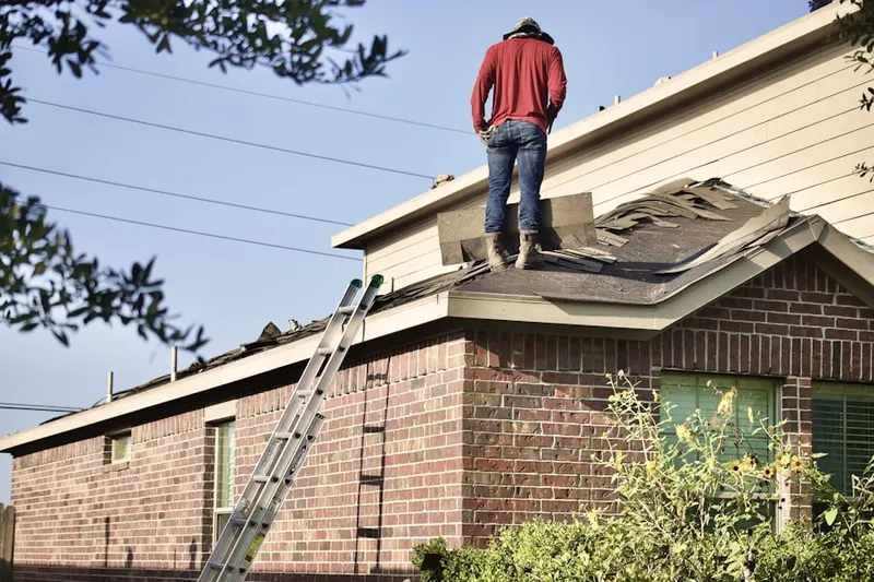 Professional roofer working on a residential roof in North Centerville